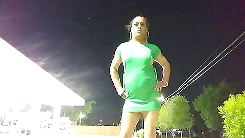 Transvestite woman walks along the street outdoors